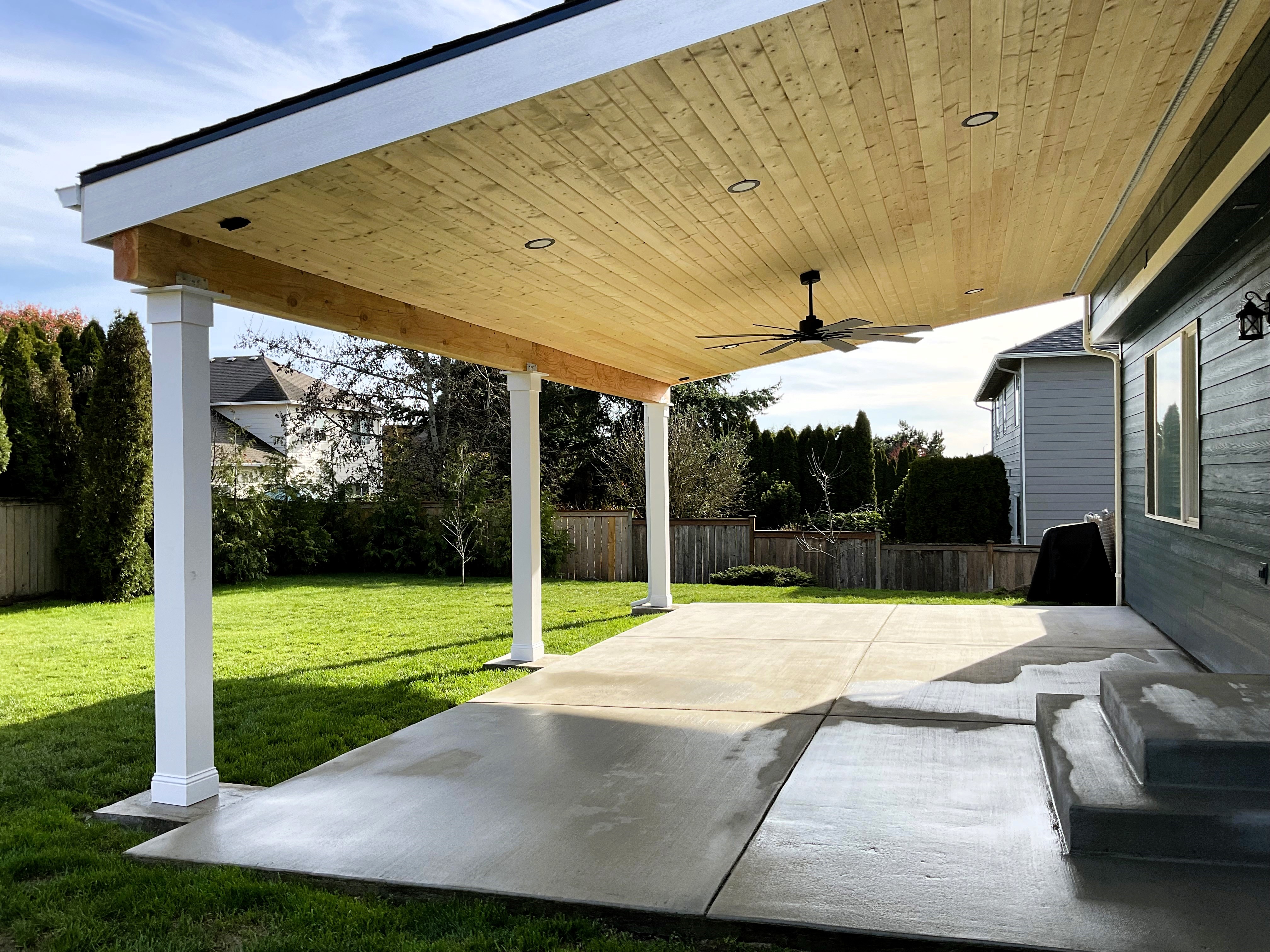 Stained pine tongue and groove ceiling with lighting and fan