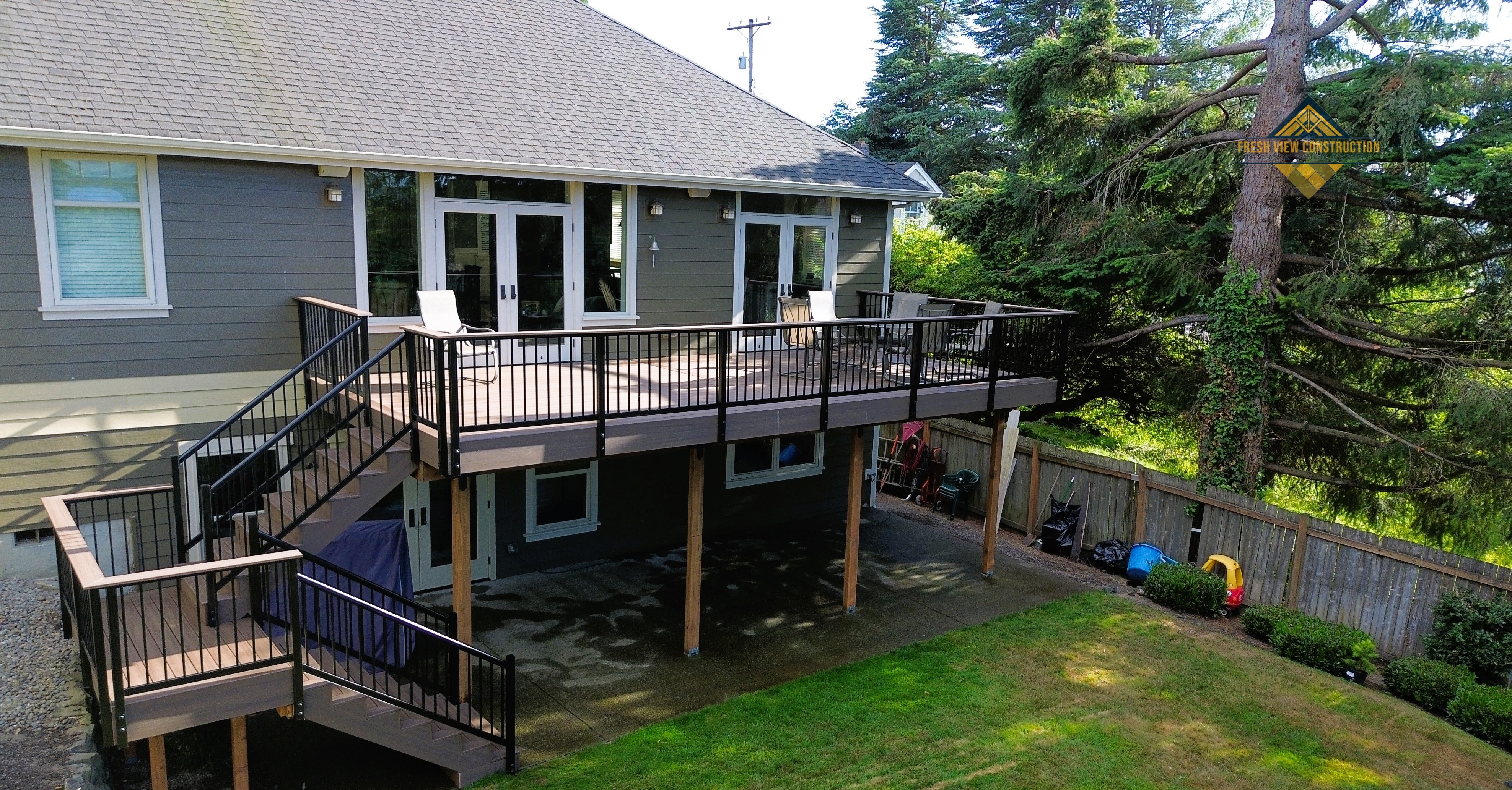 Deck stairs descending to landing before turning toward patio