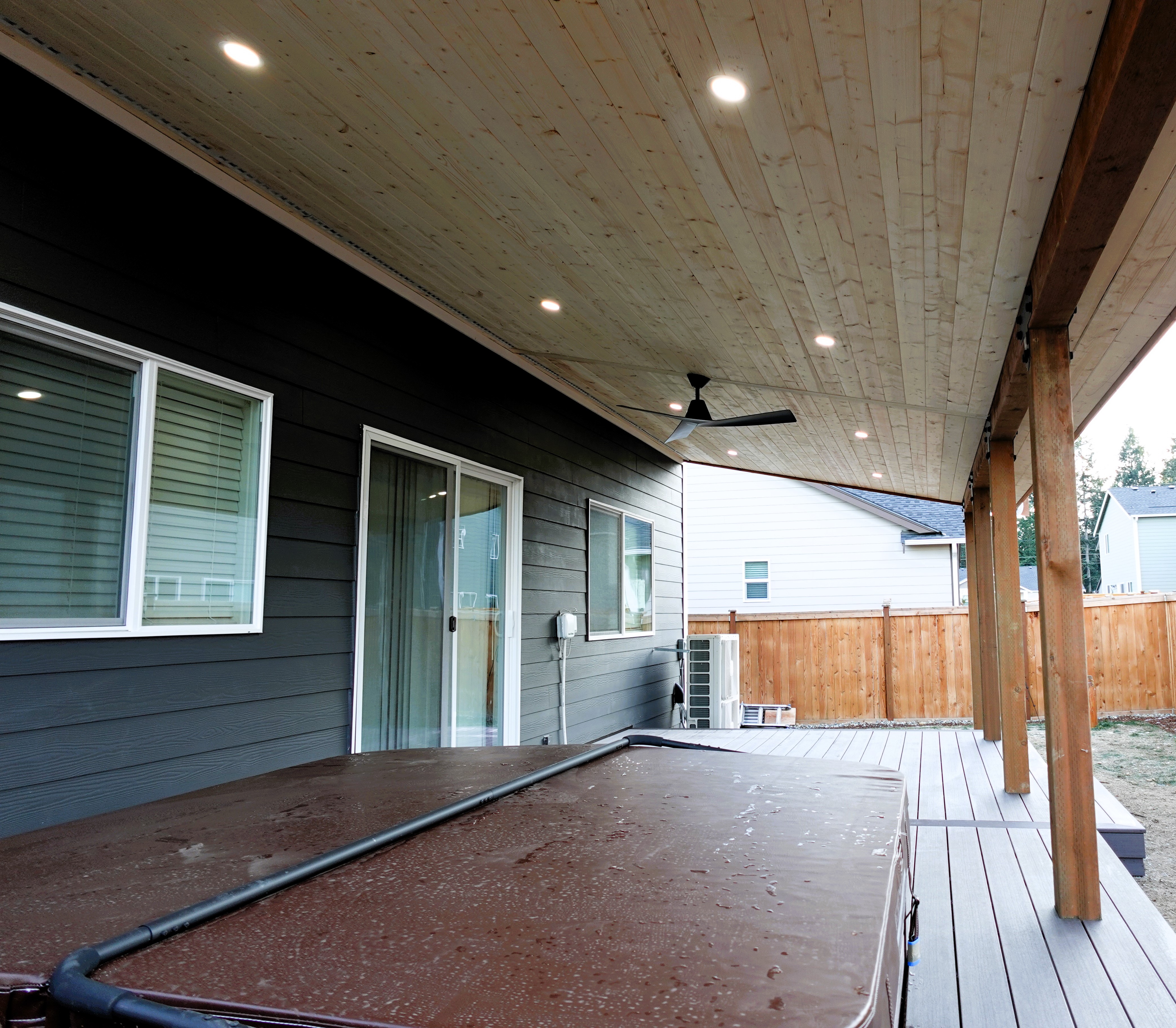Covered deck with painted white posts and beams
