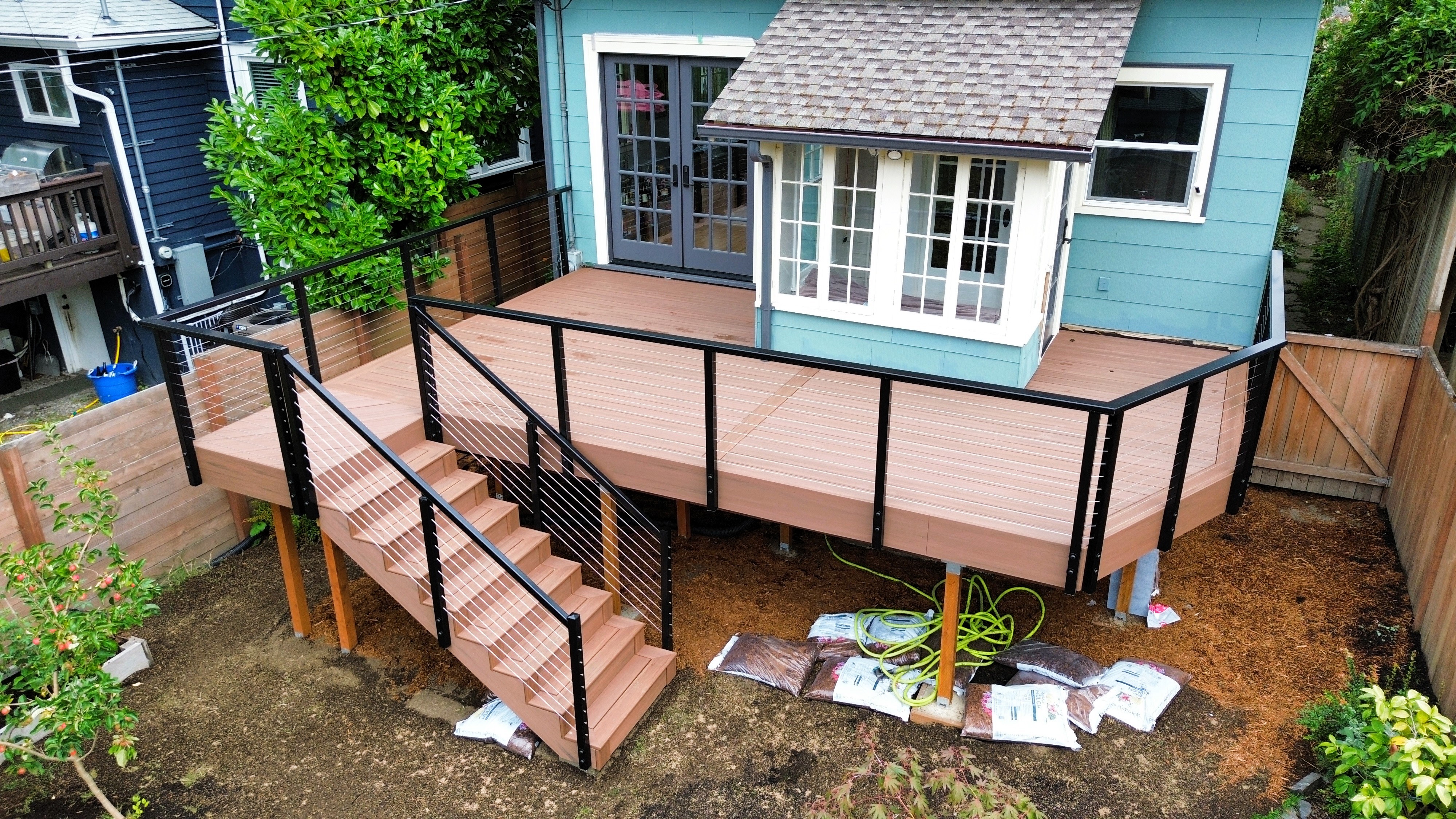 Black aluminum cable railing detail on TimberTech deck