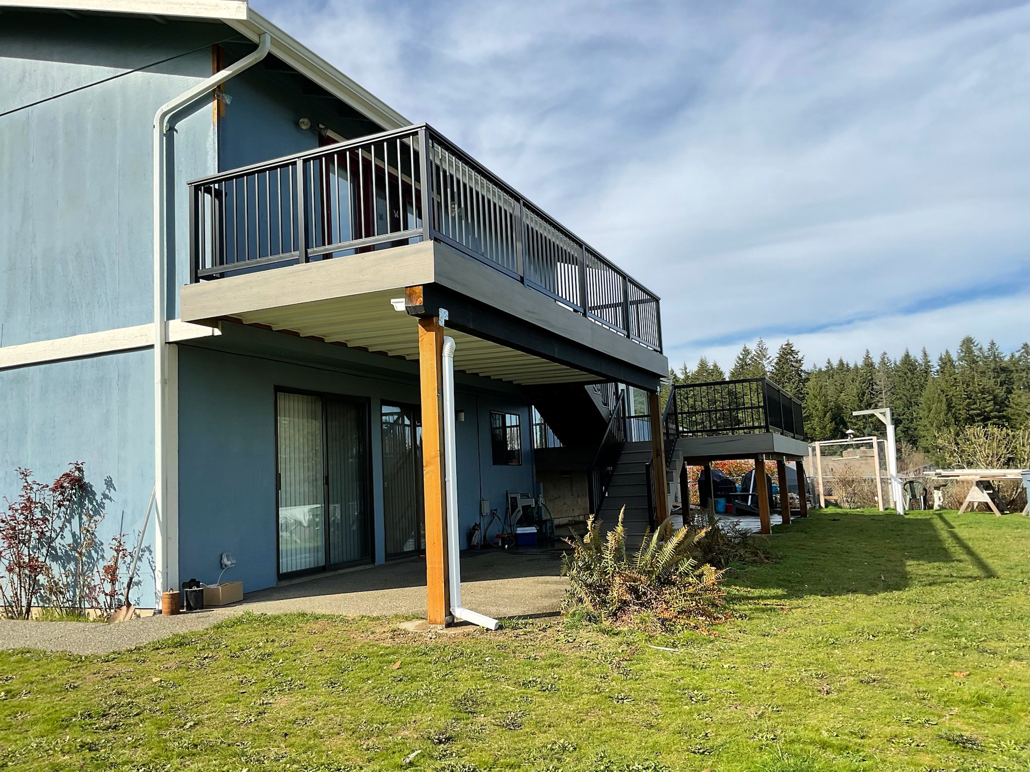 Multi-level TimberTech Driftwood deck with stairs and railing
