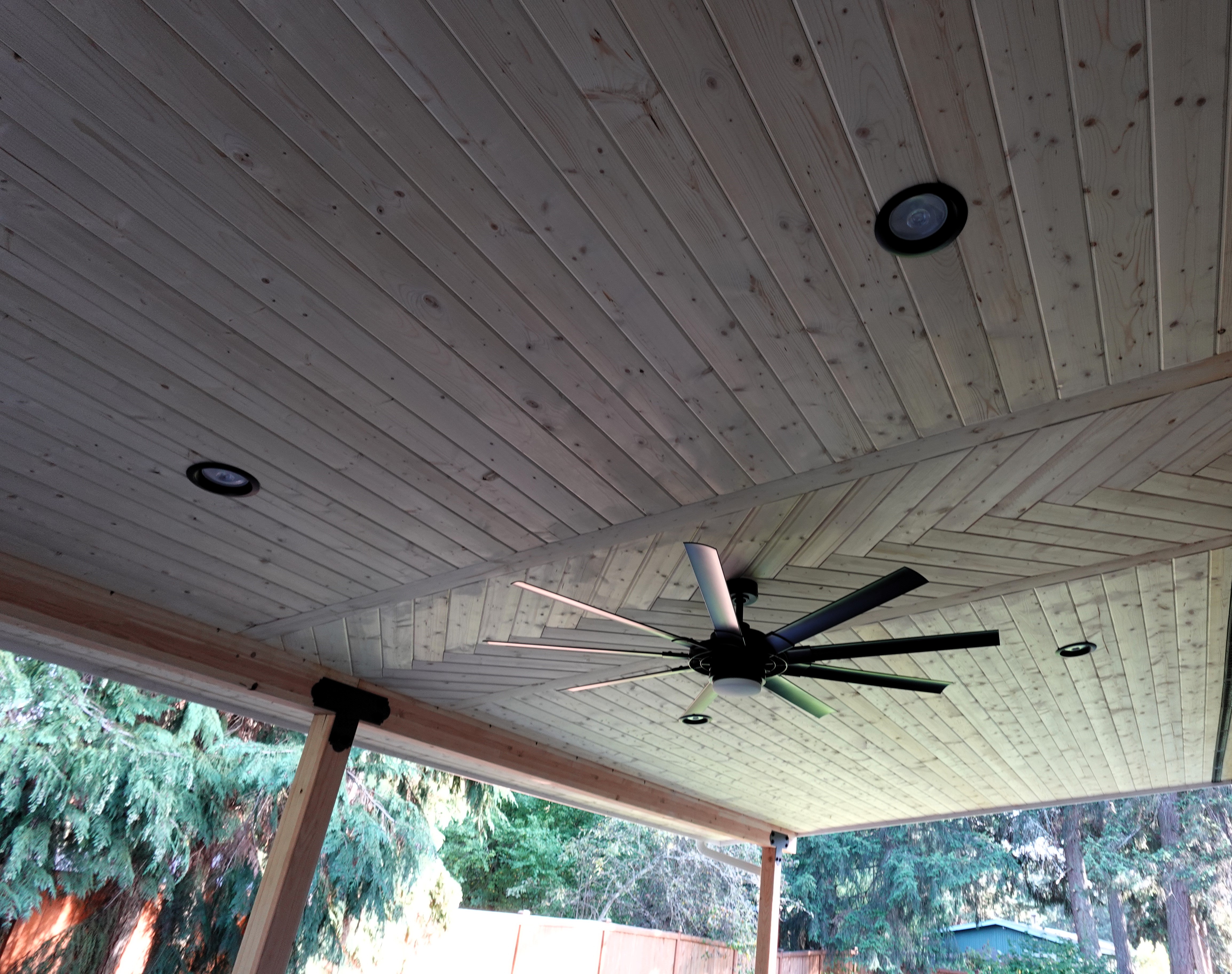 Custom deck inlay mirrored on pine ceiling detail